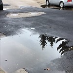 Pooling water due to Depression on Road at 3239 104 Street NW