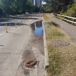 Pooling water due to Depression on Road at Queen Elizabeth Park, 10500–10542 Saskatchewan Dr Nw, Edmonton T6 E 4 S1