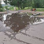 Pooling water due to Depression on Road at 9938 Groat Rd Nw, Edmonton, Ab T5 N 3 H9, Canada